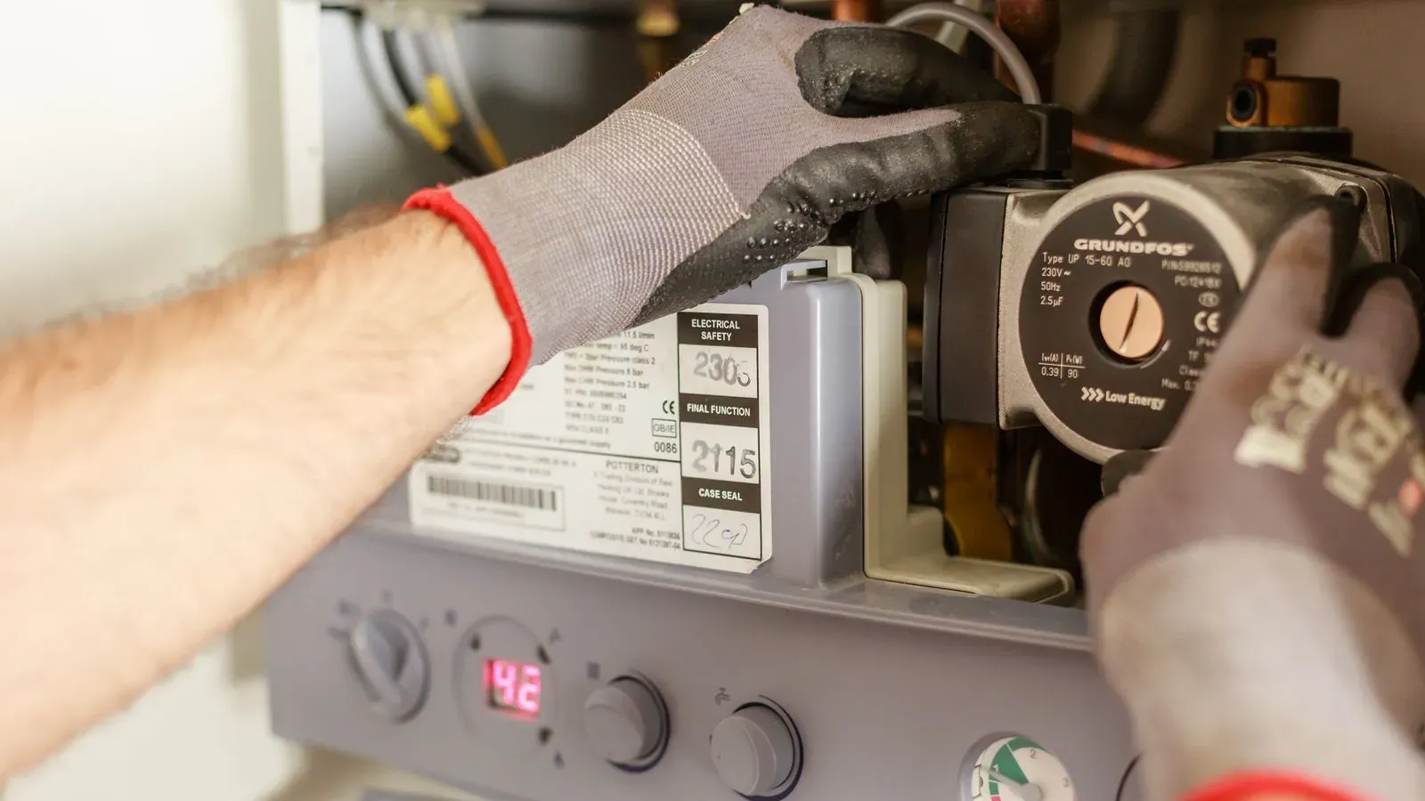 An engineer servicing a gas boiler