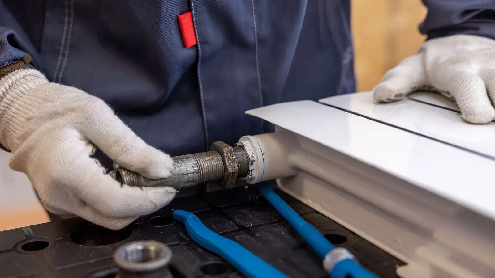 A plumber fitting a radiator pipe